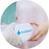 A pharmacist handing health supplies to a customer
